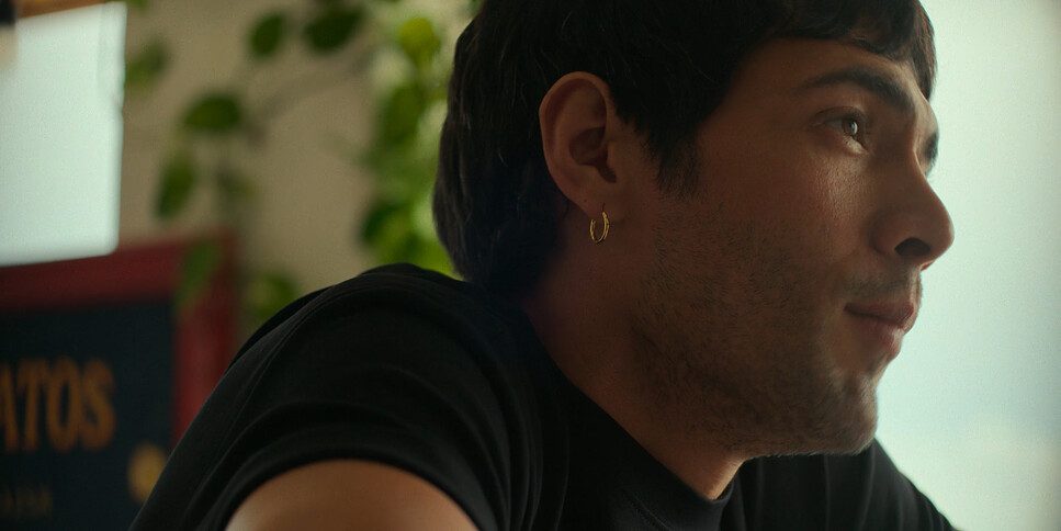 Nocturnus mood image — man in profile indoors, plants behind him