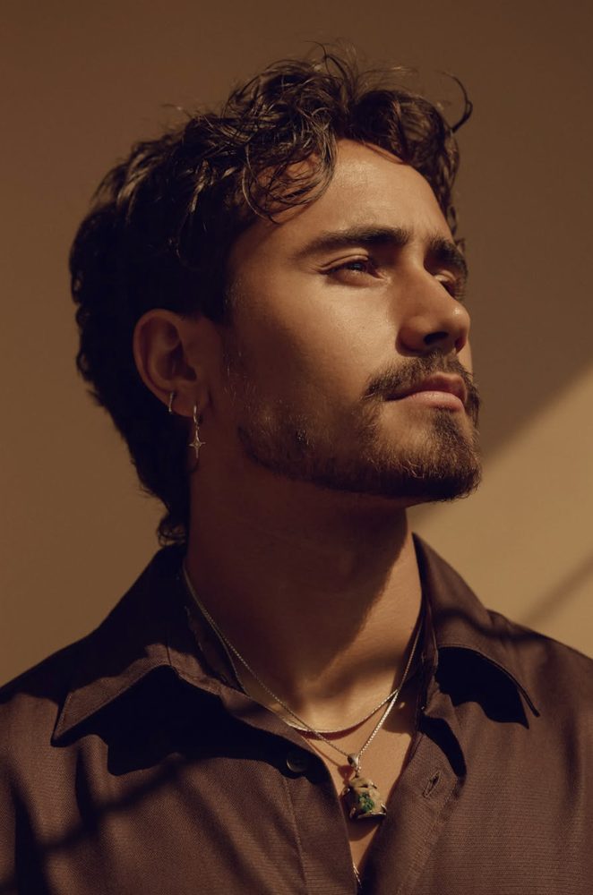 Sagrados mood image — young man in warm light, gazing upward
